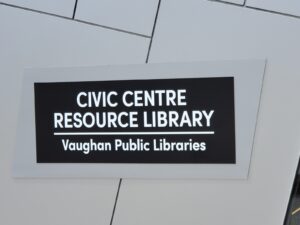 Image of the Civic Centre Resource Library sign mounted on a modern building facade, displaying "Civic Centre Resource Library" and "Vaughan Public Libraries" in white text on a black background, restored by ICON Restoration.