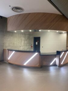 Modern City Playhouse Theatre ticket booth in Vaughan with sleek wooden paneling, LED lighting, and barrier-free design, showcasing accessibility upgrades for a vibrant community hub.