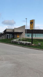 Ontario Provincial Police station entrance with sign and stone landscaping